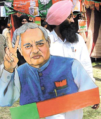 A BJP supporter with a cut-out of Atal Behari Vajpayee.