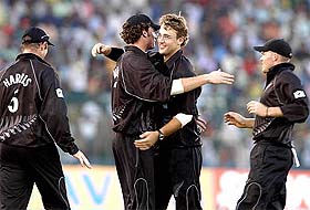 New Zealand bowler Daniel Vettori hugs Kyle Mills after taking the wicket of Yuvraj Singh