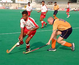 Players of BSF and Concordia Hockey Club, Croatia, fight for the ball during a league match of the 20th Indian Oil Surjit Hockey Tournament in Jalandhar