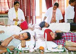 Donors donate blood at the 16th blood donation camp