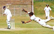 Wicket-keeper of the State Bank of India (Indore) C.P. Sahu tries to collect the ball