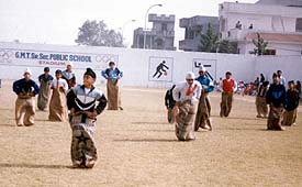 Students of GMT Senior Secondary Public School take part in sack race
