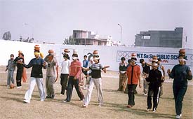 Students participate in �chatti� race at the school on Sunday