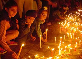 Children light candles at a gurdwara on Gurpurb in Ludhiana