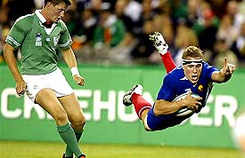 France's Imanol Harinordoquy dives to score as Ireland's Simon Easterby looks on
