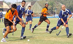 Sanjiv Kumar of Olympian XI tries to snatch the ball from Ravinder Singh Kahlon of Canada XI