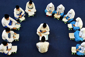 Young Malaysians take part in a special recitation of the Quran