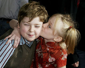 Dakota Fanning plants a kiss on the cheek of her co-star