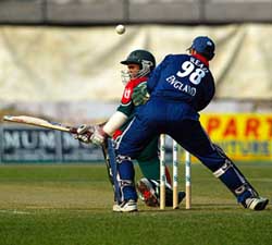 Bangladeshi batsman Rajin Saleh tries to sweep the ball as English wicketkeeper Chris Read looks on during the second one-day international match in Dhaka