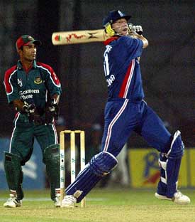 English batsman Andrew Flintoff hits a six as Bangladeshi wicketkeeper Khaled Masud looks 