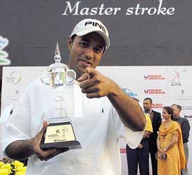 Indian golfer Arjun Atwal poses with the trophy after winning the Hero Honda Masters golf tournament in New Delhi 