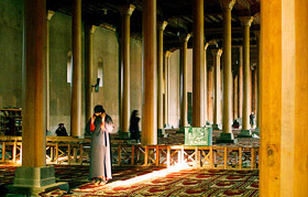 A Kashmiri woman prays inside the 600-year-old Jama Masjid