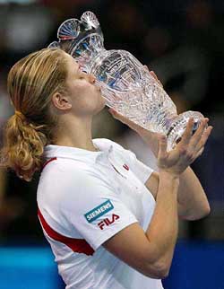 Kim Clijsters of Belgium kisses the championship trophy after defeating Amelie Mauresmo of France