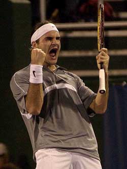 Roger Federer of Switzerland reacts after beating Andre Agassi 