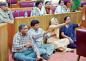 BJP-SAD councillors squat on the floor of the Municipal Corporation House to protest against a remark made by the Congress Mayor that a councillor, Ms Harjinder Kaur, was not a representative of SAD on Wednesday.