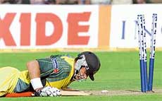 Mathew Hayden lies on the ground after being run out