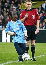 Scott Foe, son of Cameroon footballer Marc Vivien Foe, who died while playing at the Confederations Cup in France on June 26 this year, kicks of his father's memorial match at Gerland Stadium in France 