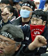 South Korean workers raise anti-government slogans at a protest rally