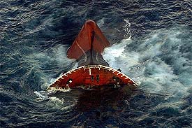 The bow of the Prestige oil tanker floats above water moments before sinking