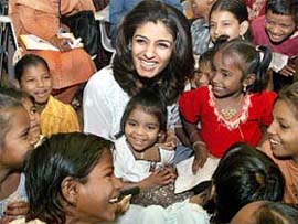 Bollywood star Raveena Tandon is all smiles as she mingles with underprivileged children on the eve of Children’s Day in Mumbai