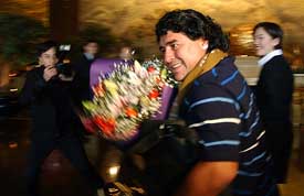 Soccer legend Diego Maradona arrives at a hotel in Beijing 