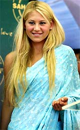 Tennis player Anna Kournikova poses for photographers in a sari before a Press conference 
