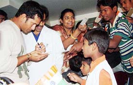 Master blaster Sachin Tendulkar signs autographs for young fans during his visit to the Care Hospital on the eve of Children�s Day in Hyderabad