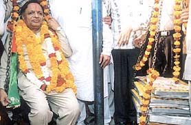 Worth his weight in Ladoos: BJP candidate Nand Kishore Garg from Trinagar constituency being weighed by his supporters in the Capital on Saturday