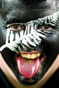 A New Zealand rugby fan sticks his tongue out before the first semi-final of the Rugby World Cup