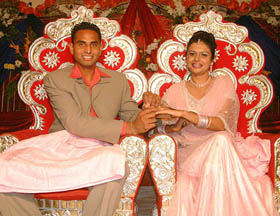 Hockey star and full back Kanwalpreet Singh along with his fiancee is all smiles during their engagement ceremony in Jalandhar on Saturday.