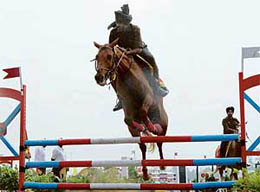 Amandeep leaps on his horse in the junior jumping event of Shivalik Horse Show