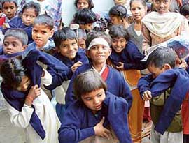 Children of a school being run by the Piya Sharma Charitable Trust are all smiles as they try their new sweaters at Rajiv Colony, Panchkula, on Sunday. 