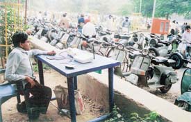 Mr Lalji Singh, who runs a PCO from a table in New Courts Complex
