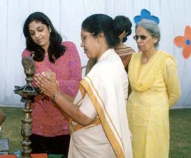 Sister Helima, Principal, Sacred Heart Convent School, lights the ceremonial lamp at annual day function