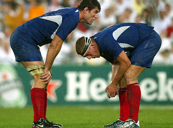 France's Fabien Pelous and teammate Imanol Harinordoquy react after their Rugby World Cup semi-final loss to England
