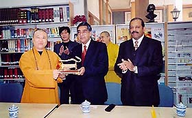 Mr Nalin Surie, Indian Ambassador to China, presents the Tripataka set in Pali to the chief of the Jade Buddha temple Abbot Jue Xing in Shanghai