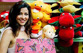 Former Mrs World and Bollywood star Aditi Gowitrikar displays items prepared by under-privileged children at a shopping centre in Mumbai