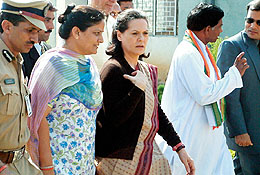 Opposition Leader and Congress Party President Sonia Gandhi walks along with unidentified officials during her election campaign in Chhattisgarh�s Bhillai town 
