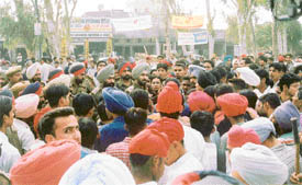 Policemen try to pacify students agitating against the death of a student in Jagraon on Tuesday