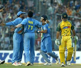 Virender Sehwag, Murali Kartik and Rahul Dravid celebrate the dismissal of Australian captain Ricky Ponting