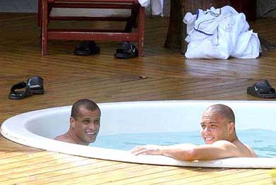 Brazilian soccer stars Rivaldo and Ronaldo relax in a swimming pool at a hotel outside Curitiba