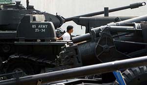 A man touches a US tank, displayed at the War Museum in Ho Chi Minh City, Vietnam