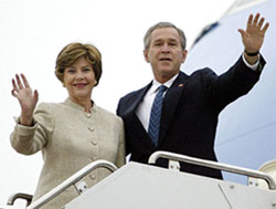 US President George W. Bush and first lady Laura Bush wave from the steps of Air Force One at Andrews Air Force Base in Maryland 