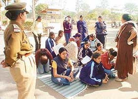 A teacher persuades striking students to attend classes as a policewoman looks on at GCG, Sector 11, Chandigarh