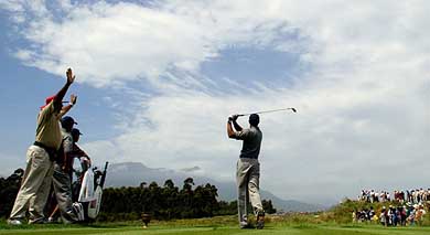 US golfer Tiger Woods plays off the third tee during the President's Cup Golf tournament at the Fancourt Golf Estate in South Africa