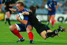 New Zealand's Steve Devine tackles France's Brian Liebenberg during their third place play-off match at the Rugby World Cup in Sydney 