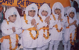 Children attired in traditional dress take part in nagar kirtan to mark the martyrdom day of Guru Teg Bahadur