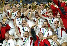 Jubilant England players celebrate after winning their maiden Rugby Cup title, at the Olympic stadium in Sydney