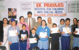 Autistic students who won medals at Special Olympics proudly display their certificates