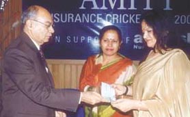 ASIAS director R. R. Grover presenting a cheque for Rs 50,000 to Amitasha chairperson Amita Chauhan, at the Amity Insurance Cricket Cup Tournament on Saturday